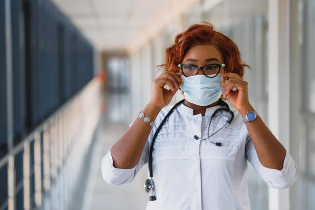 Young black doctor in mask
