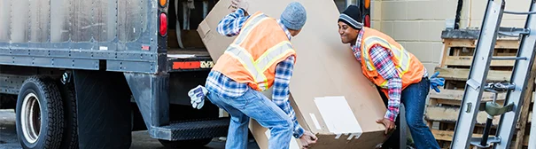 Two workers loading a truck
