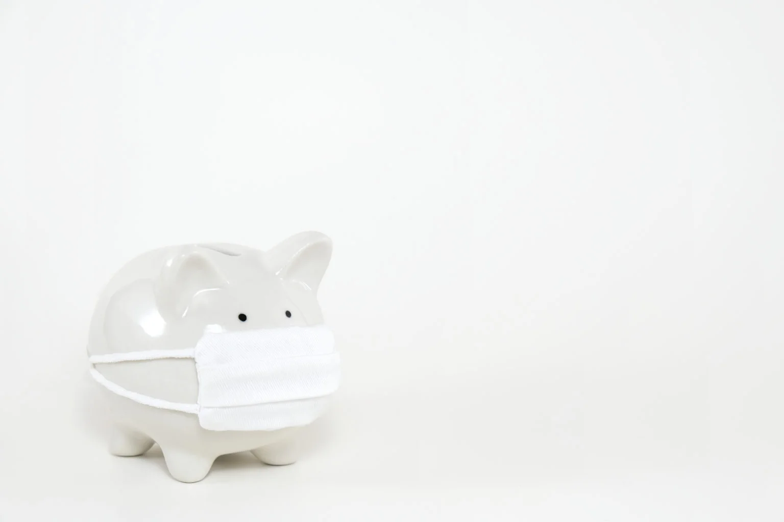 White,Ceramic,Piggy,Bank,Wearing,Surgical,Mask,On,White,Background