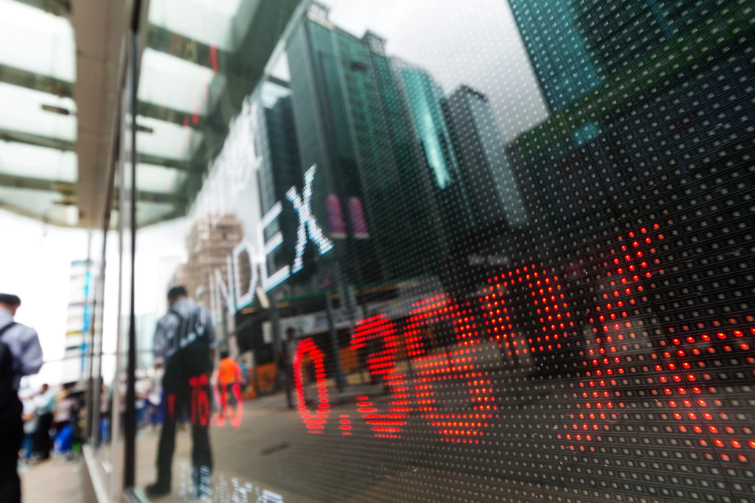 Display of stock market quotes with a city scene on glass